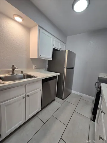 a kitchen with a sink cabinets and stainless steel appliances