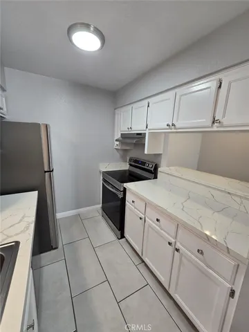 a kitchen with cabinets and appliances