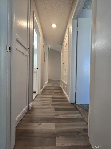 a view of a hallway with wooden floor