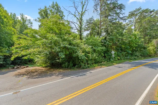 a view of a road with a bench