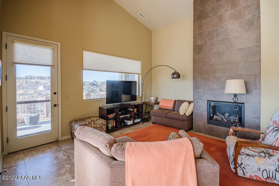 1594 Rustling Wind Place Prescott, AZ 86301 - Photo 20 of 47 a living room with furniture a flat screen tv and a fireplace