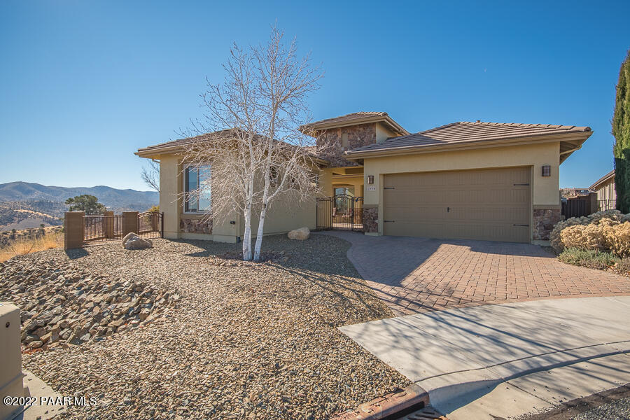 1594 Rustling Wind Place Prescott, AZ 86301 - Photo 2 of 47 a bedroom with a bed and a potted plant