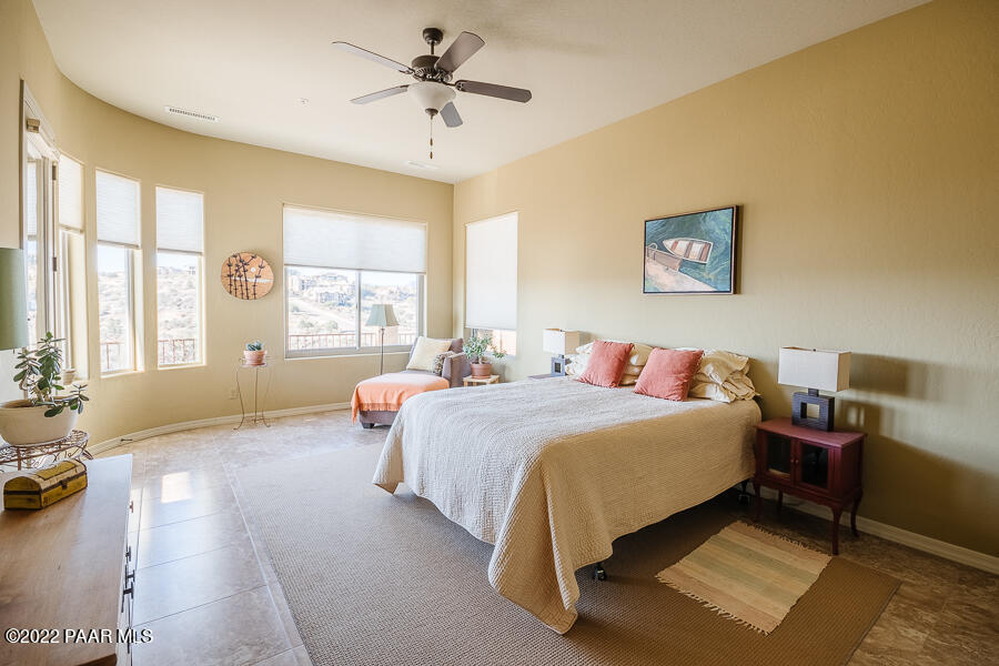 1594 Rustling Wind Place Prescott, AZ 86301 - Photo 22 of 47 a spacious bedroom with a bed a couch and a large window