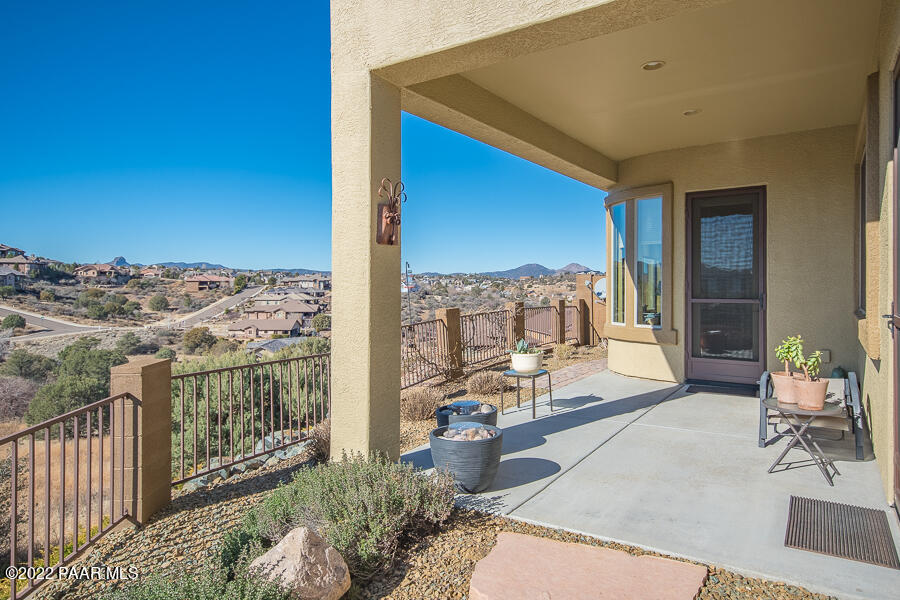 1594 Rustling Wind Place Prescott, AZ 86301 - Photo 24 of 47 a balcony with furniture and a floor to ceiling window