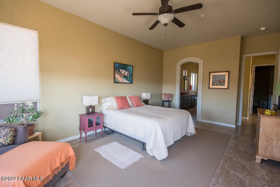 1594 Rustling Wind Place Prescott, AZ 86301 - Photo 25 of 47 a bedroom with a bed and a chandelier