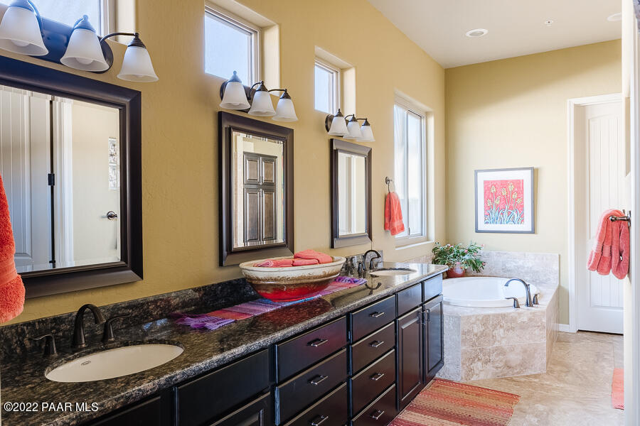 1594 Rustling Wind Place Prescott, AZ 86301 - Photo 26 of 47 a bathroom with a granite countertop sink and a mirror
