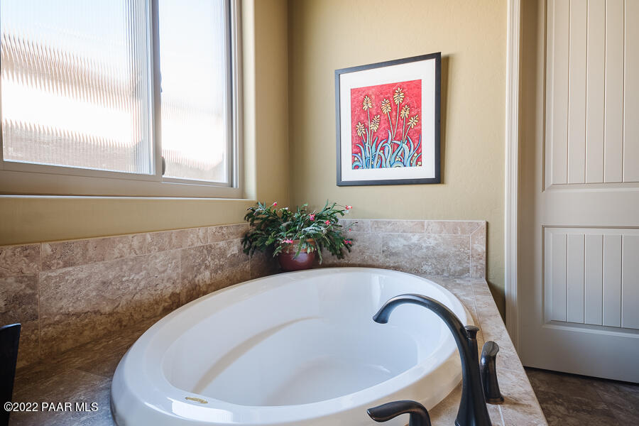 1594 Rustling Wind Place Prescott, AZ 86301 - Photo 27 of 47 a bathroom with a bathtub and a window