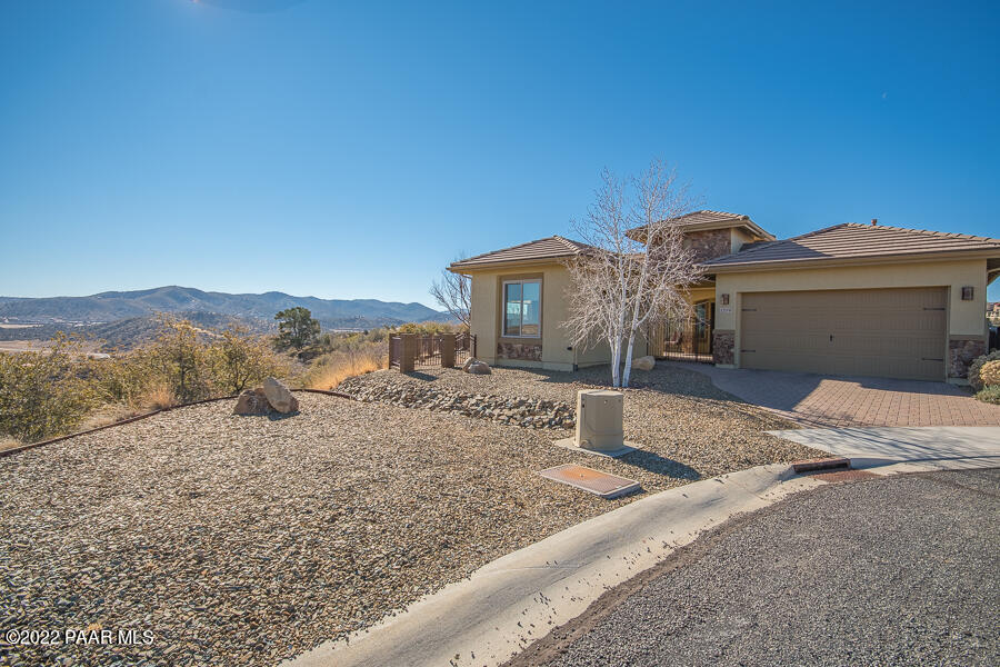 1594 Rustling Wind Place Prescott, AZ 86301 - Photo 3 of 47 a view of a house with a yard and large tree