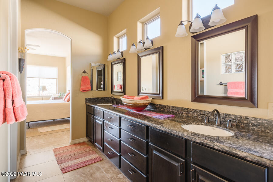 1594 Rustling Wind Place Prescott, AZ 86301 - Photo 31 of 47 a bathroom with a granite countertop sink and a mirror