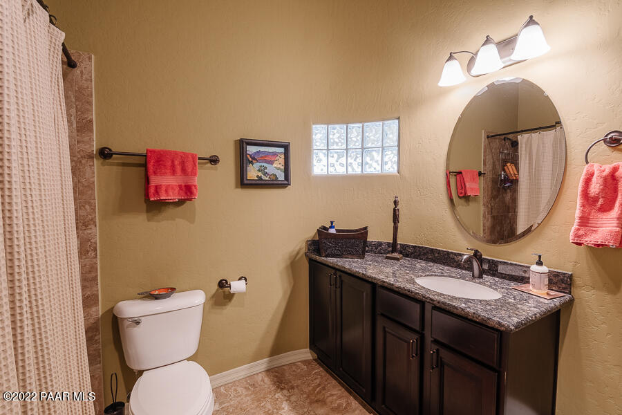 1594 Rustling Wind Place Prescott, AZ 86301 - Photo 34 of 47 a bathroom with a toilet a sink and mirror