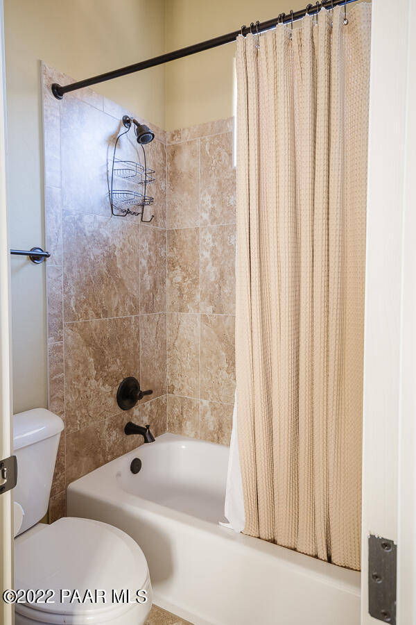 1594 Rustling Wind Place Prescott, AZ 86301 - Photo 41 of 47 a bathroom with a toilet and a shower curtain