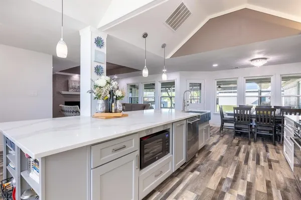 a kitchen with stainless steel appliances kitchen island granite countertop lots of counter top space and furniture