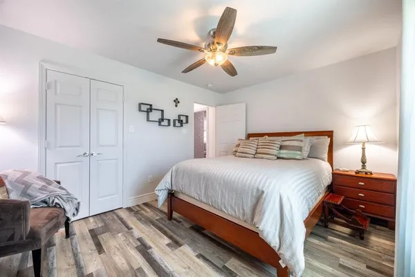 a bedroom with a bed and a ceiling fan