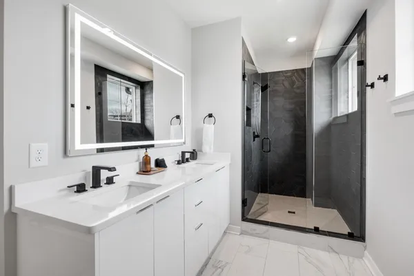 a kitchen with stainless steel appliances granite countertop a sink a stove a refrigerator and island with wooden floor