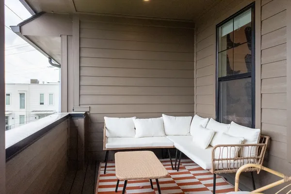 a kitchen with stainless steel appliances a stove a sink a microwave a dining table and chairs