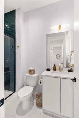 a view of a hallway with white walls and chandelier