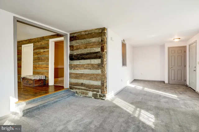 a view of an empty room with a fireplace