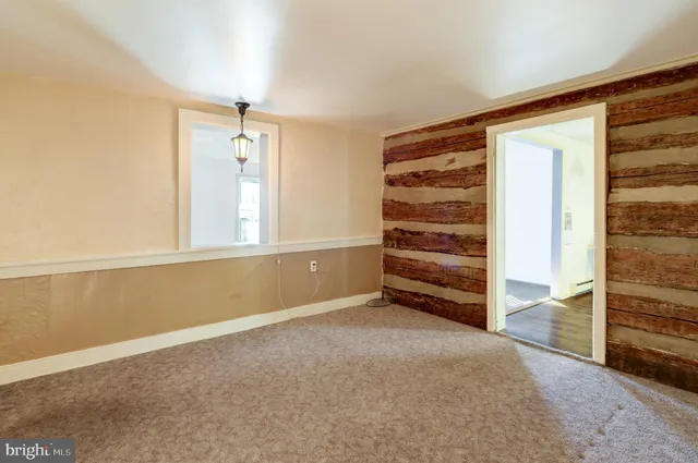 a view of an empty room with a cabinet