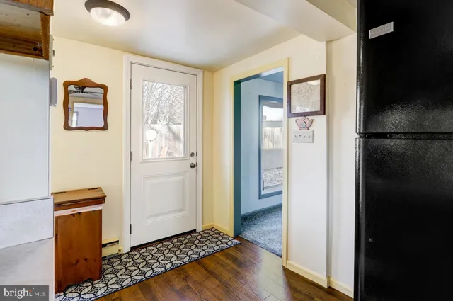 a view of a livingroom with wooden floor and a cabinet