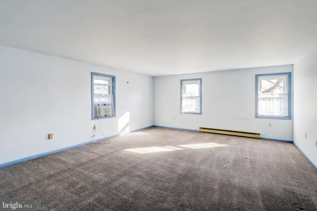 a view of an empty room and entryway
