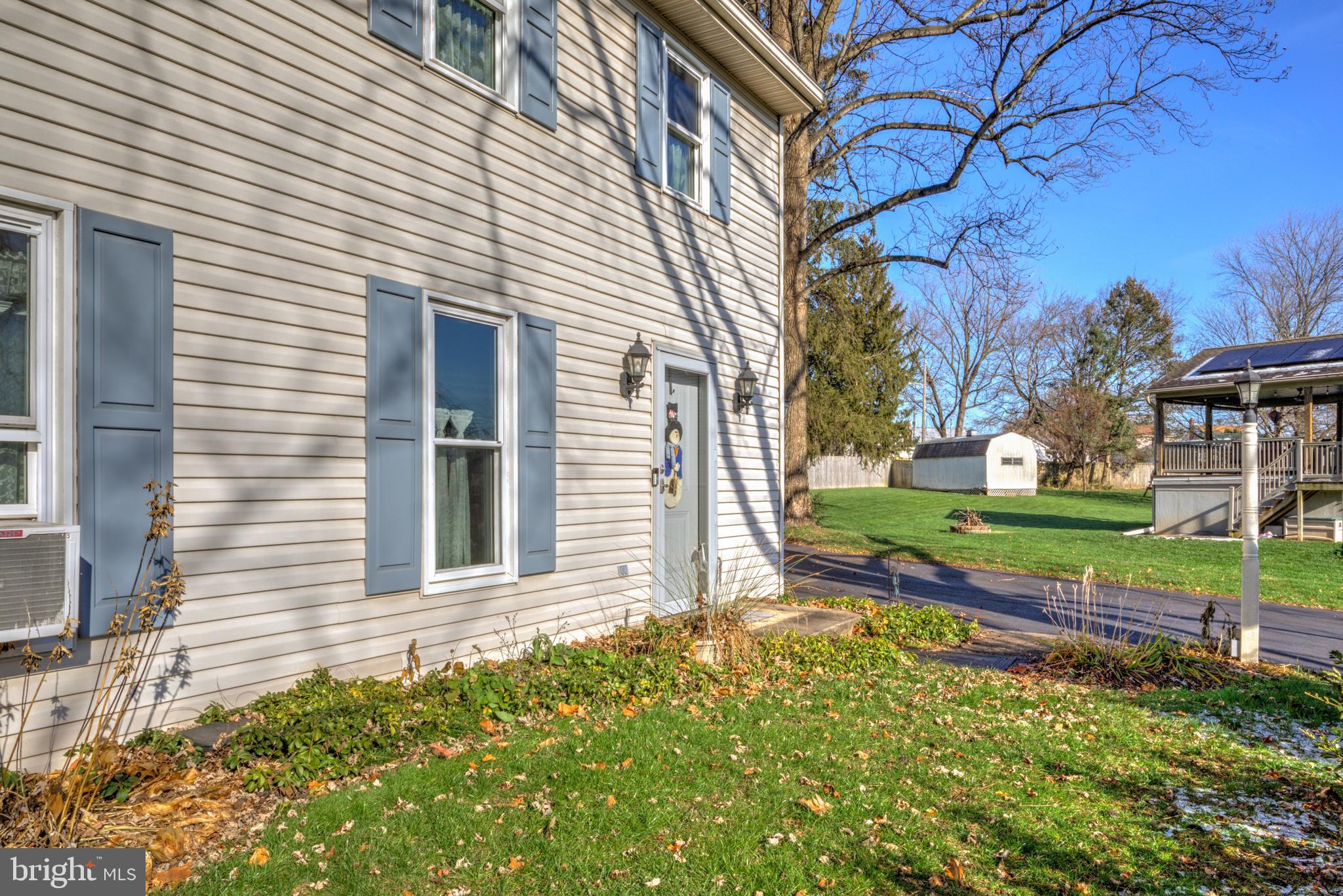 206 Pleasant Hill Drive Lititz, PA 17543 - Photo 5 of 35 a view of a house with a small yard and wooden fence