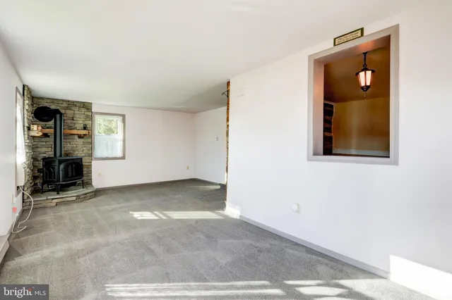 an empty room with windows and closet