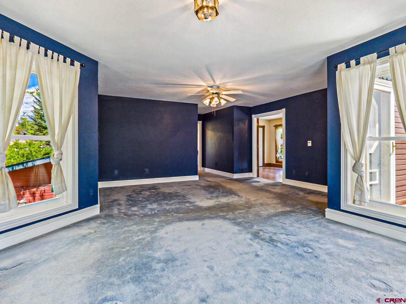 16331 2550th Road Cedaredge, CO 81413 - Photo 27 of 45 a view of a hallway with a chandelier fan and window