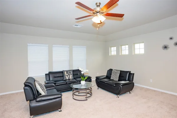 a living room with furniture a couch and a chandelier
