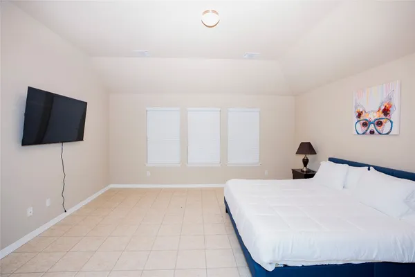 a bedroom with a bed and a flat screen tv