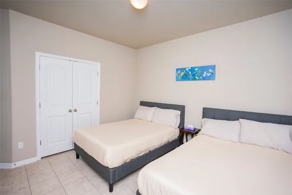 a bedroom with two beds and a night stand