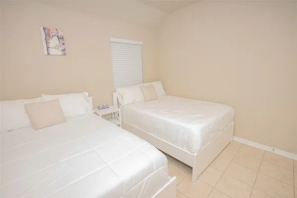 a bedroom with two beds and a night stand