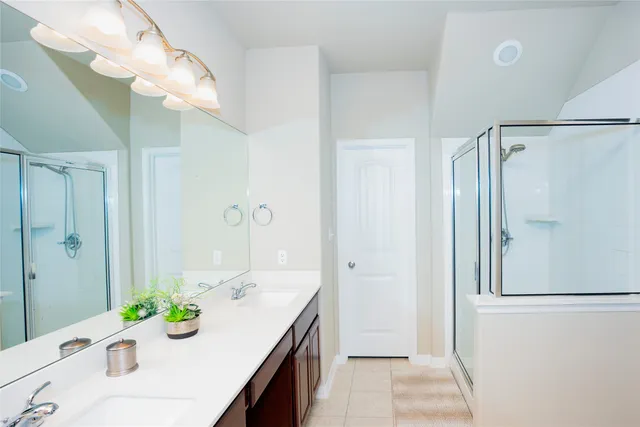 a bathroom with a sink double vanity and shower