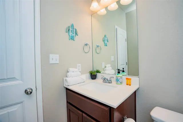 a bathroom with a sink vanity and a mirror