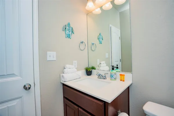 a bathroom with a sink vanity and a mirror