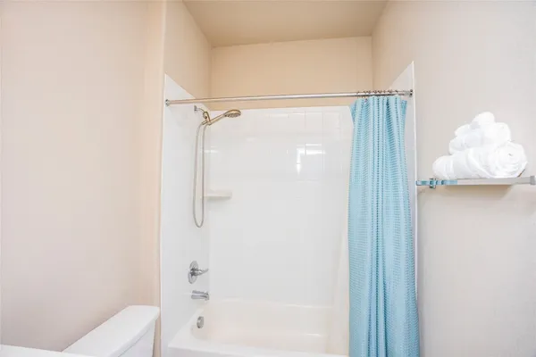 a bathroom with a shower and a toilet