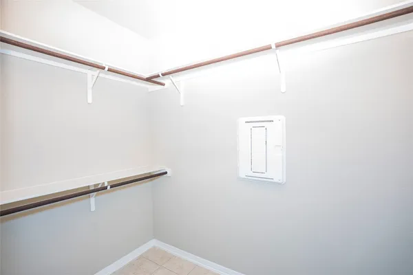 a view of a room with racks on the wall and a window