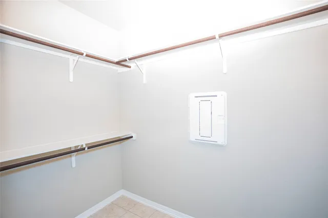 a view of a room with racks on the wall and a window