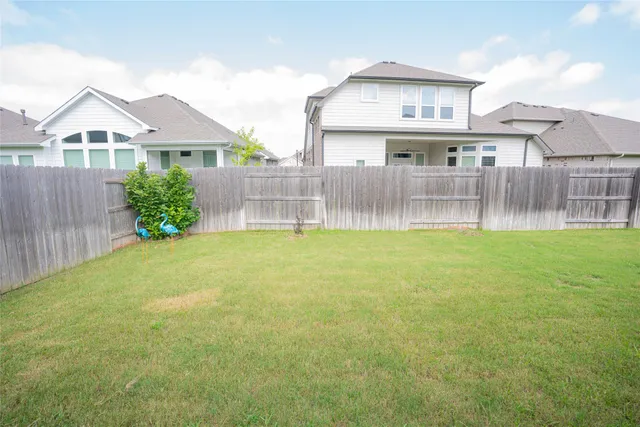 a view of a house with a yard and a porch