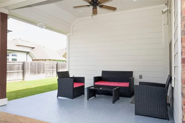 a backyard view of a house with a garden and patio