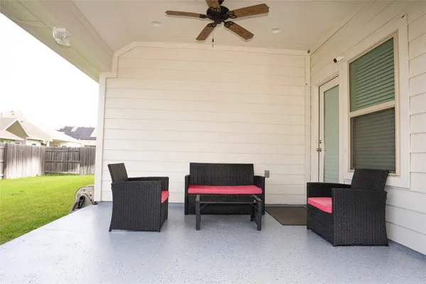 a backyard view of a house with outdoor seating