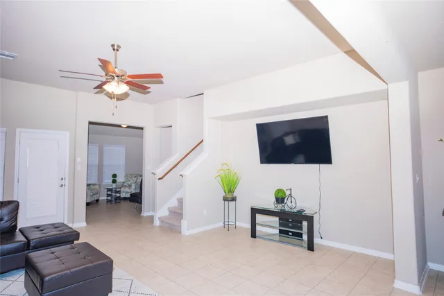 a living room with furniture and a lamp