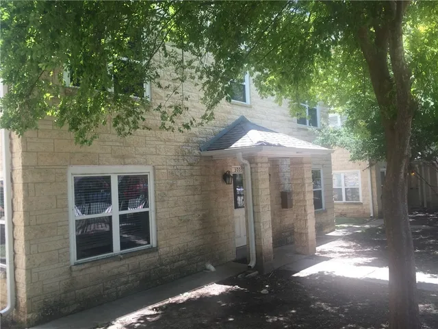a view of a large tree in front of a house