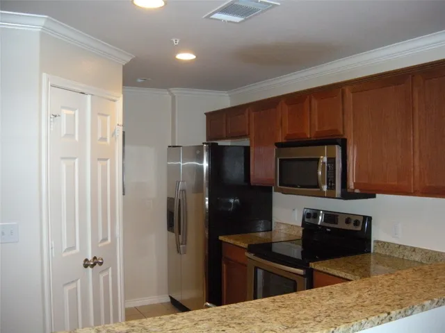 a kitchen with a refrigerator microwave and sink