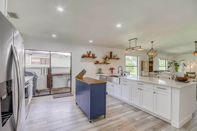 a kitchen with cabinets and wooden floor
