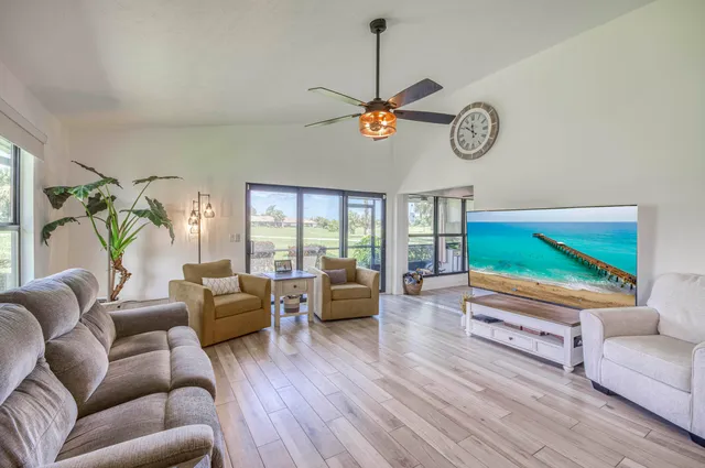 a living room with furniture a window and a flat screen tv