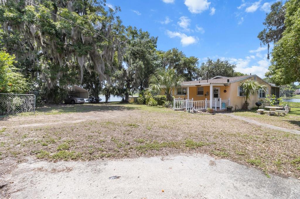 1226 South Telephone Point Road Inverness, FL 34450 - Photo 16 of 43 a front view of a house with a yard