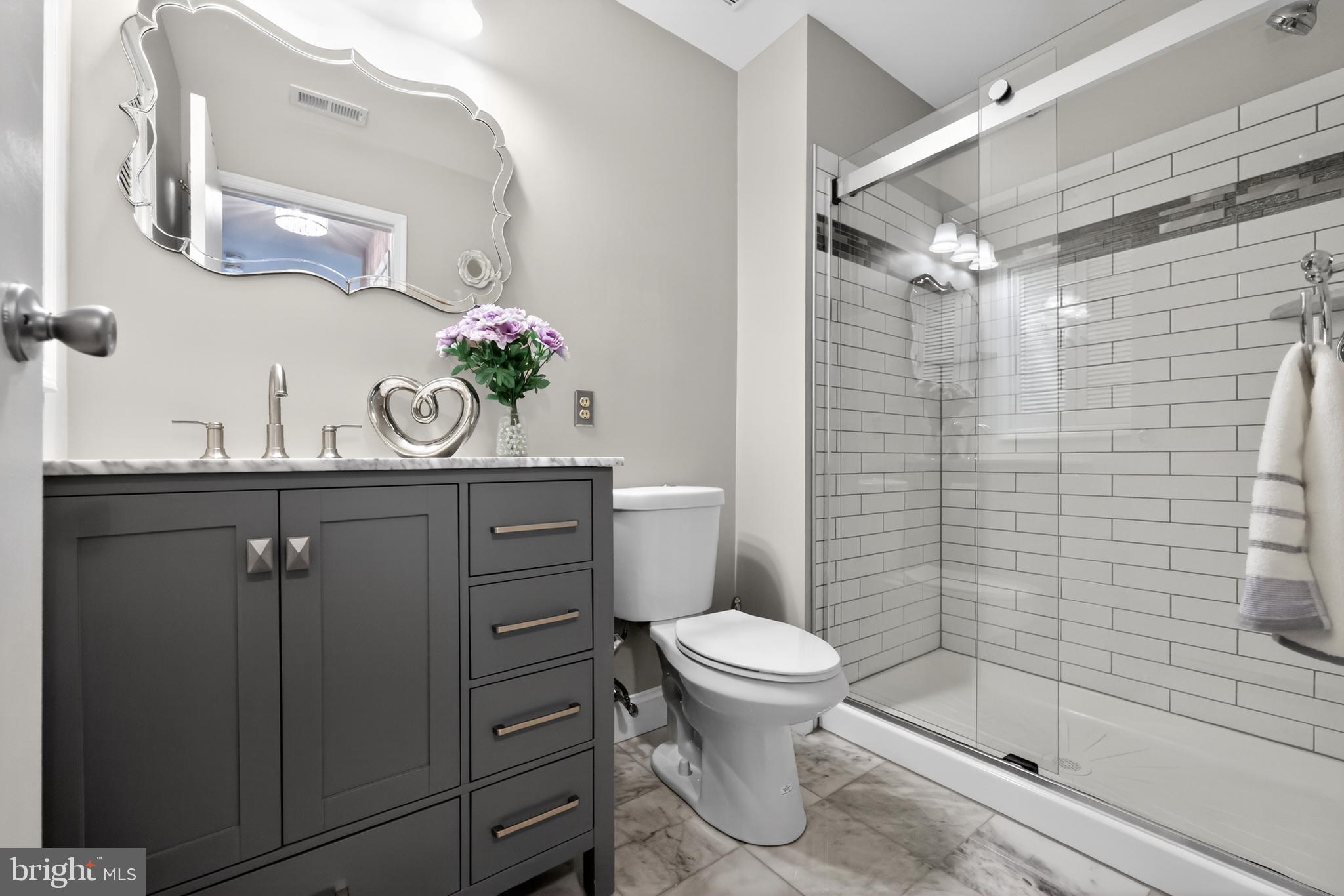 213 Tavistock Road Cherry Hill, NJ 08034 - Photo 13 of 24 a bathroom with a sink a toilet and shower