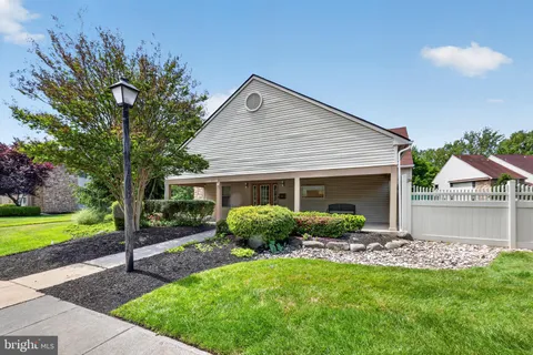 a view of a house with a yard and a garden