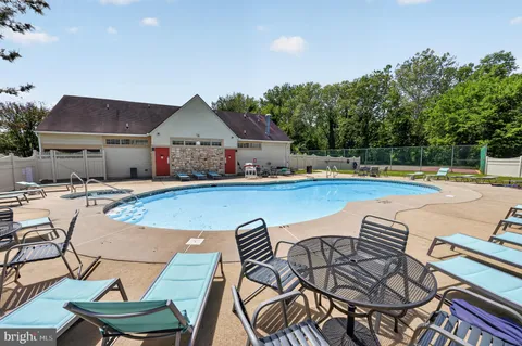 a view of a swimming pool with lounge chairs