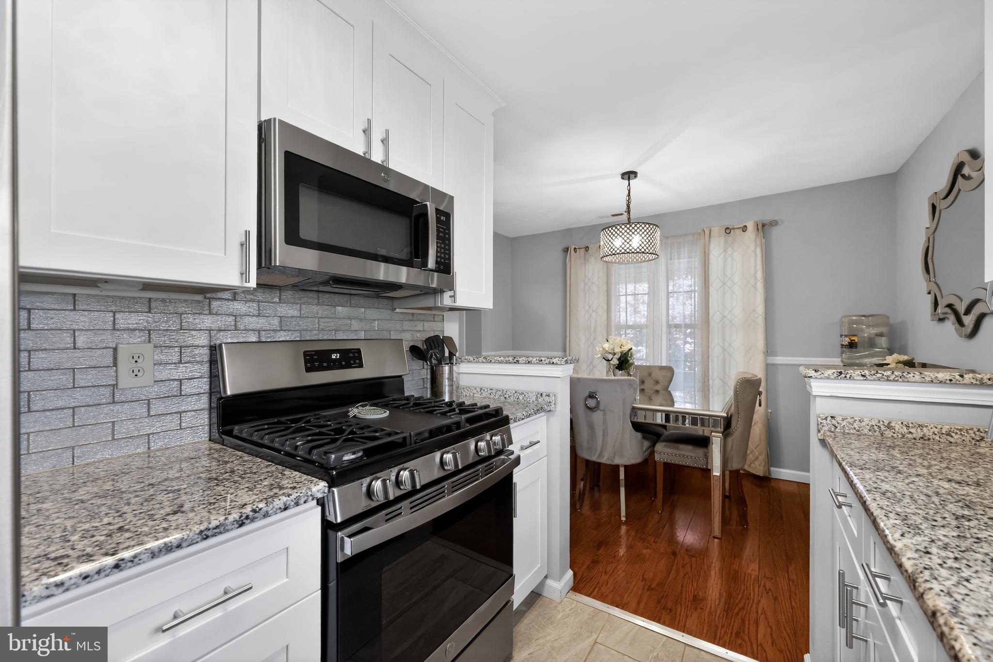 213 Tavistock Road Cherry Hill, NJ 08034 - Photo 6 of 24 a kitchen with a stove and a microwave